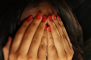 woman covering face with hands