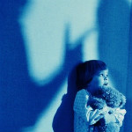 boy hugging bear shadows blue scared boy