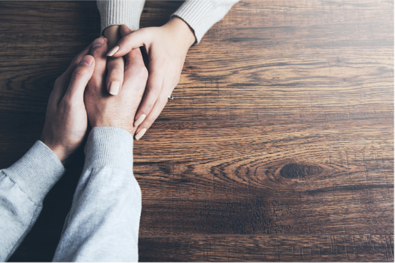 Adults who have been through childhood domestic violence embrace lovingly